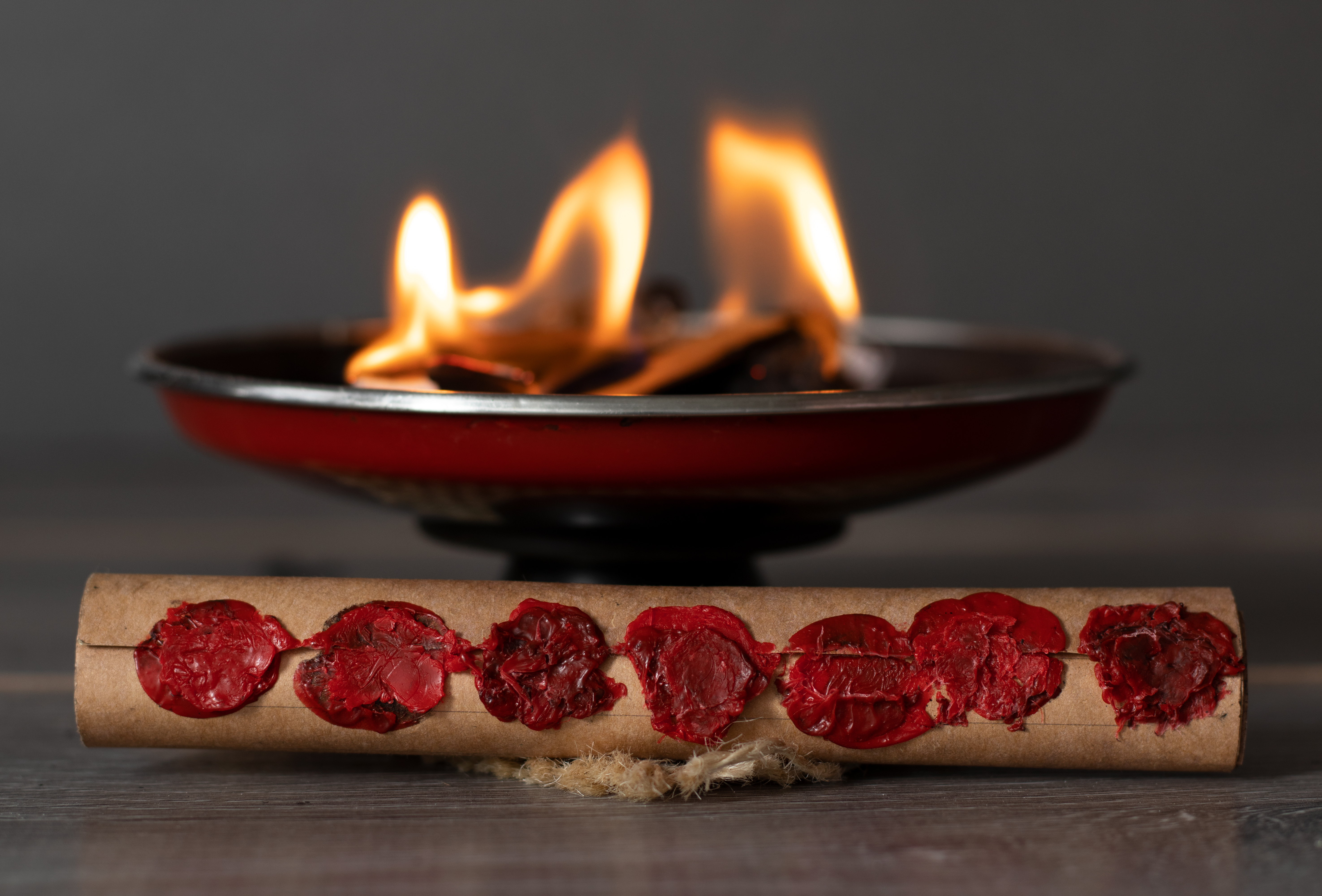 scroll with seven seals in front of a burning fire flames